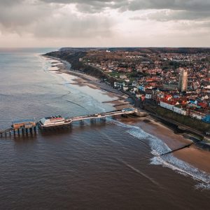 bird-eye-shot-city-public-beach-pier-gloomy-day_181624-28622